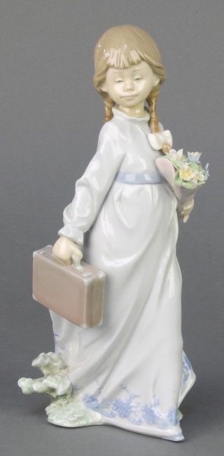 A Lladro figure of a girl with suitcase 7604 8" 