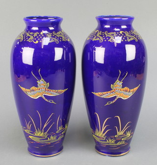 A pair of Empire Ware blue ground oviform vases decorated with exotic birds 13" 