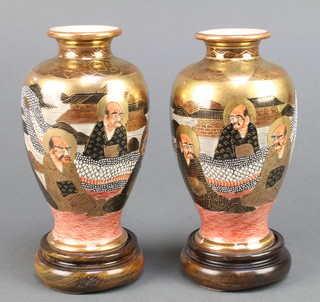 A pair of Japanese Satsuma vases decorated with figures 6 1/4", seal mark to base with wooden stands 6" 
