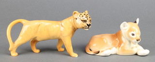 A Beswick figure of a standing lion cub 6 1/2", a Russian figure of a reclining ditto 5" 