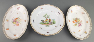 A German porcelain dinner plate decorated with birds enclosed by insects 10", a pair of oval serving dishes with floral and gilt decoration 11" 