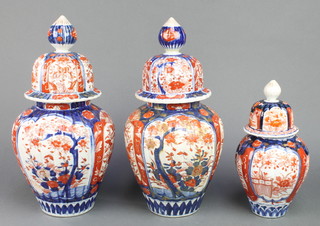 A pair of late 19th Century Imari baluster vases and covers decorated with flowers 14" together with a smaller ditto