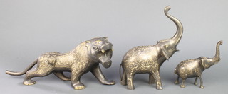 An Afghan gilt figure of a walking lion 15" and 2 ditto elephants 10" and 6" 