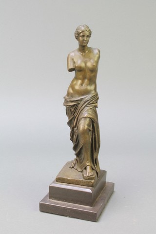 A bronze figure of a standing Venus de Milo, raised on a stepped black marble base 12"
