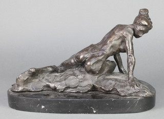A bronze figure of a recumbent lady raised on an oval base 8" 
