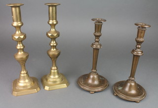 Gibbons of Wolverhampton, a pair of Victorian bronze candlesticks raised on 4 bun feet 10", a pair of Victorian brass candlesticks with knopped stems 12" 
