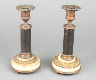 A pair of Regency ormolu and onyx candlesticks raised on 3 bun feet 8 1/2"h