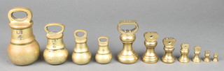 4 graduated brass bell weights 4lbs, 2 lbs, 1lb, 8 ozs, together with a set of 7 brass bell weights 1lb, 8 ozs, 4 ozs, 2 ozs, 1 oz, 1/2 oz, 1/4oz, 