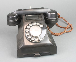 A black  Bakelite dial telephone the handset marked 164 46/1, the base marked 33CB PX 55/2A 