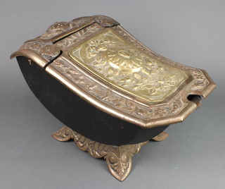 A cast iron boat shaped coal box with hinged lid 