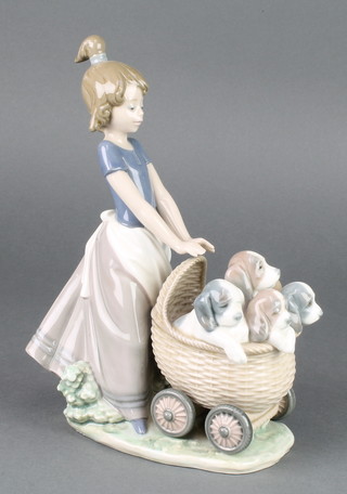 A Lladro figure of a girl pushing a pram of puppies 5364 9" 