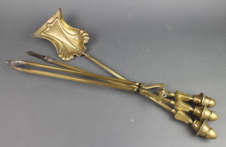 An Art Nouveau style brass 3 piece fireside companion set 