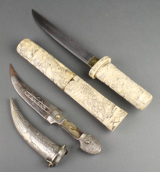 A Japanese dagger with 8" blade and carved bone grip contained in a carved bone scabbard decorated Samurai together with an Eastern dagger with 6" blade