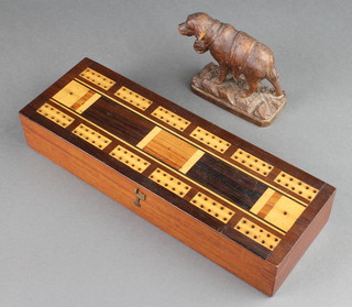 A Swiss carved wooden figure of a St Bernard raised on a rocky outcrop 3 1/2" (ear and tail f), together with a 19th Century rectangular inlaid mahogany cribbage board containing dominoes 2"h x 10"w x 3 1/2"d 