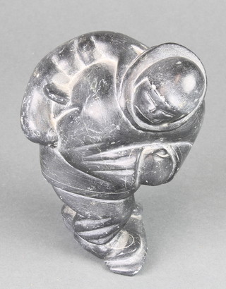 Sallie, a carved Inuit hardstone figure of a walking gentleman with seal 5 1/2", the base marked Sallie Kak
