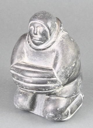 A carved Inuit hardstone figure of a kneeling gentleman 6" 
