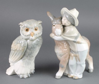 A Lladro figure of a boy with donkey 8 1/2" and a Nao figure of an owl 7" 