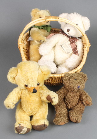 A yellow Merrythought teddybear with articulated limbs 11", a white Russ Timeless teddybear 12", a Harrods Merrythought teddybear 11"  and a brown bear 7", all contained in a wicker basket 