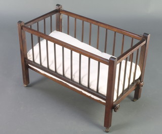 A childs wooden toy cot with drop down sides 17"h x 24"w x 12 1/2"d 