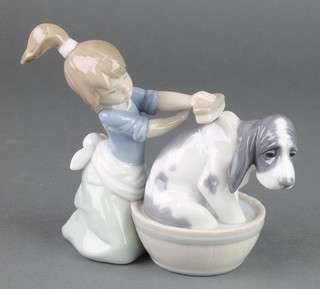A Lladro figure of a girl scrubbing a hound in a barrel 5455 5" 