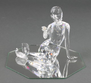 A Swarovski figure of a mermaid holding a pearl on a mirrored base 4" 
