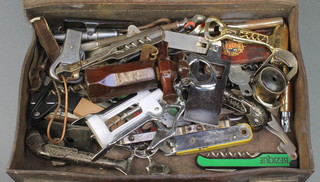 A small leather attache case containing a collection of Crown Cork bottle openers and other curios, cigarette card books etc 