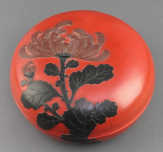 A circular Japanese red lacquered box and cover, the lid decorated chrysanthemum 3" x 7 1/2" diam. 