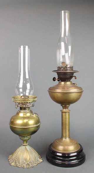 A brass oil lamp reservoir with clear glass chimney (no shade) and 1 other with chimney (no shade) 