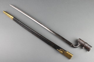 A socket bayonet complete with leather and brass mounted scabbard 