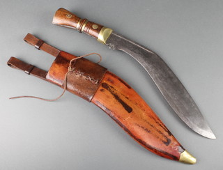 A military issue Kukri the 13 1/2" blade marked with crows feet complete with leather scabbard 