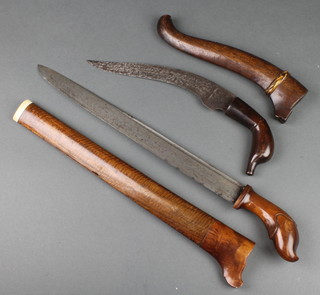 An Indonesian dagger with 13 1/2" straight blade contained in a wooden scabbard (cracked) with 1 other Indonesian dagger with curved 9" blade contained in a wooden scabbard