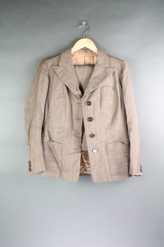 A lady's 1950's 2 piece brown pinstripe suit comprising jacket and trousers (moth to arm), a lady's 1970's tweed double breasted coat
