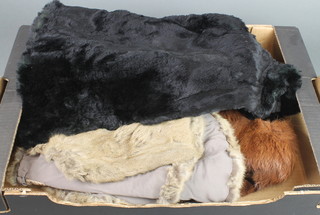 A lady's brown fox fur cape, a black fur cape and 1 other 