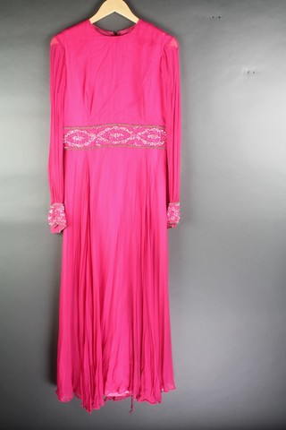 Mayon Couture and Bakes Sportswear of Mayfair, a lady's pink long sleeved evening dress with beadwork detail to the waist and arms, size 16 together with a 1960's gold lame evening dress 