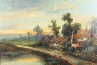 F E Jameson, oil on canvas, signed, sunset study of a rural scene with country cottages 15 1/2" x 23" 
