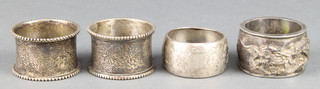 A Chinese repousse silver napkin ring decorated with dragons and 3 others, 124 grams