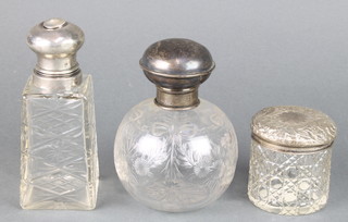 A cut glass spherical scent bottle with silver lid Birmingham 1918 and 2 others