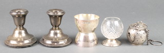 A silver tot measure Sheffield 1929, 46 grams, a silver lidded scent, a tea infuser and pair of dwarf candlesticks 