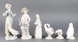 A Lladro figure of a boy with fishing rod 8", a ditto of a girl feeding a goose 10" and a Lladro figure of a girl holding a piglet and 1 Nao and 2 Lladro geese 