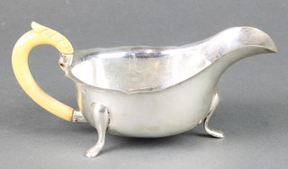 A silver sauce boat with cut rim and ivory handle 166 grams