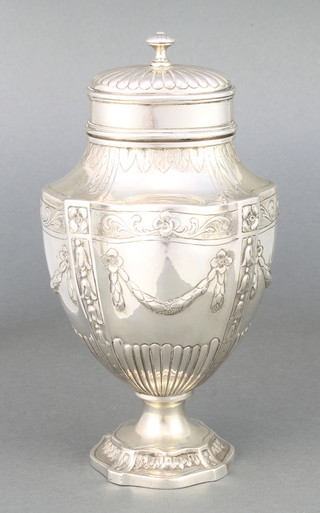 A late 19th Century Austro Hungarian repousse silver tea caddy and lid in the form of a classical urn decorated with swags and demi-fluted decoration, stamped Schwarz & Steiner, 290 grams, 6 1/2" 