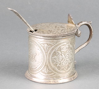 A Victorian circular silver mustard pot with chased floral decoration London 1881 together with a spoon 112 grams 