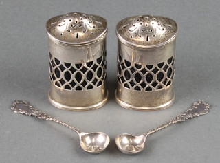 A pair of Edwardian silver peppers with chased decoration and blue glass liners Chester 1905 together with 2 spoons 98 grams 