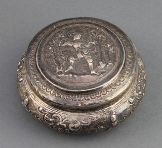 A repousse Indian silver circular box and cover decorated figures 86 grams