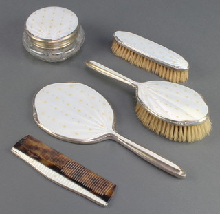A silver and guilloche enamel dressing table set comprising lidded jar, hair brush,clothes brush, comb and hand mirror