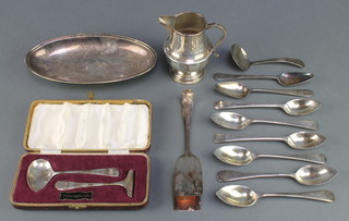 A silver pedestal cream jug Birmingham 1936, a silver pusher and spoon 126 grams and minor plated items