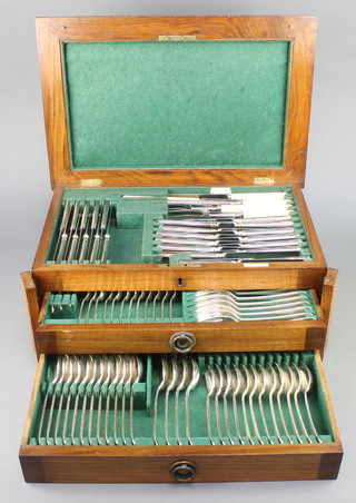 An Edwardian canteen of silver plated cutlery for 10 contained in a fitted oak canteen