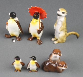 A Beswick figure of a penguin with umbrella 802 4 1/2", ditto holding an umbrella 803 4", 2 small ditto with right turned head 2", a John Beswick figure of a Meerkat 2" and otters 2" 