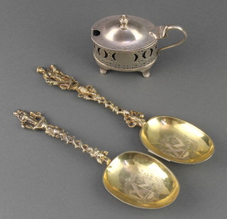 Two 19th Century Continental silver gilt apostle spoons with chased armorial bowls 92 grams, a Victorian silver oval mustard Birmingham 1895