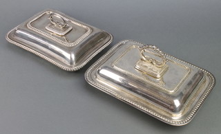 Two silver plated entree dishes and covers